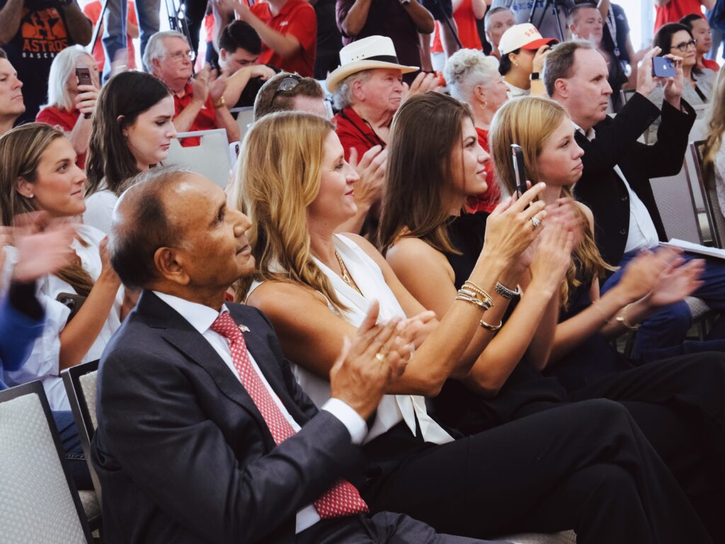 Renu Khator's husband Suresh Khator, the associate dean of engineering, Jane Nunez, Elie Nunez and Anna Nunez watch Eddie Nunez make his first appearance at UH's new athletic director. Eddie Nunez leans on his wife and daughters for support. (Photo by F. Carter Smith)