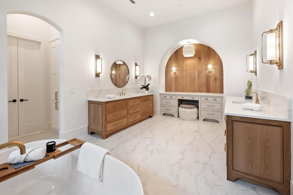 Custom woodwork and cabinetry with a deep soaking tub.