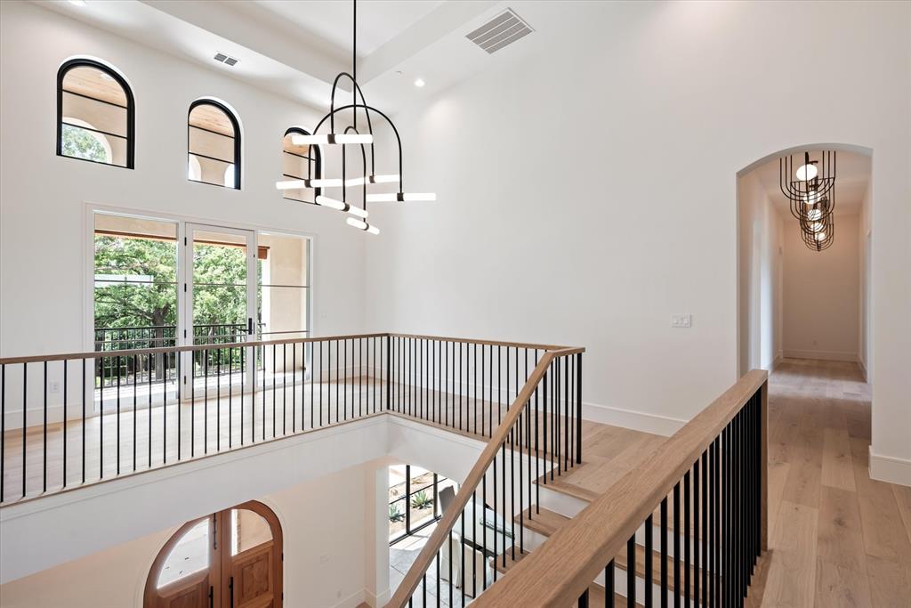 The upstairs landing fitted with modern lighting overhead.