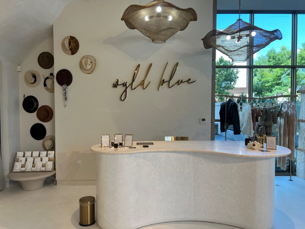 The custom-marble checkout at Wyld Blue Dallas