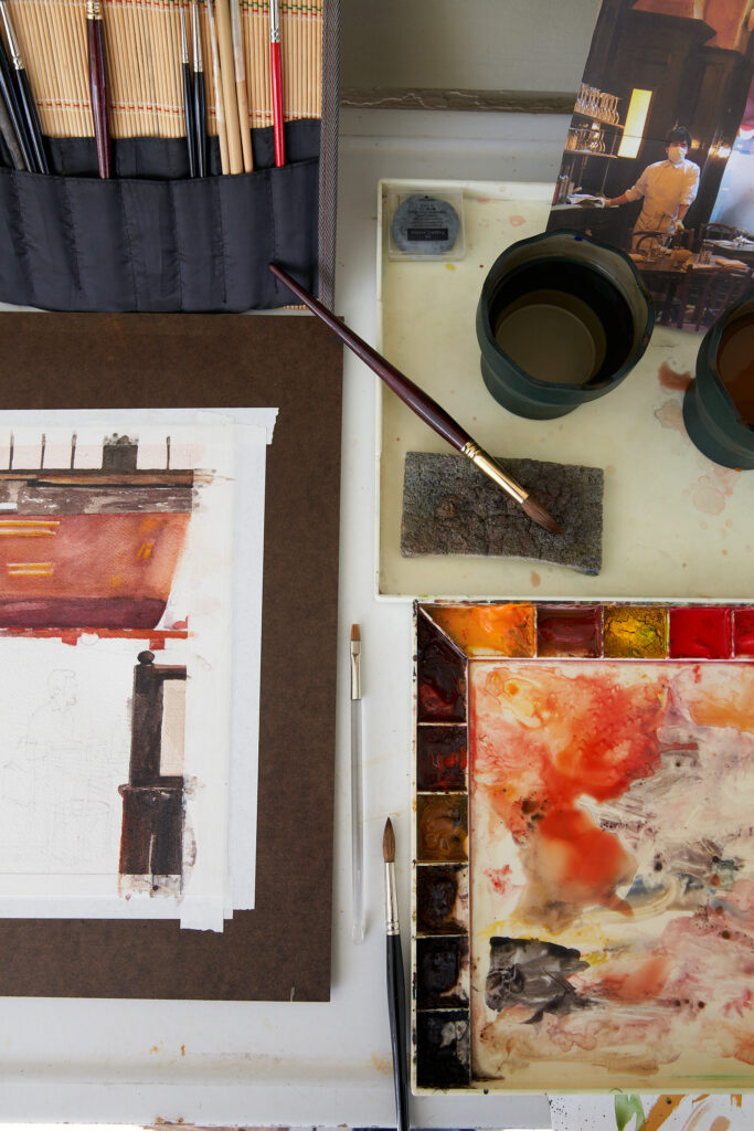 Curtis at work on a painting, referencing a photo he took inside Balthazar in NYC. (Photography Pär Bengtsson)