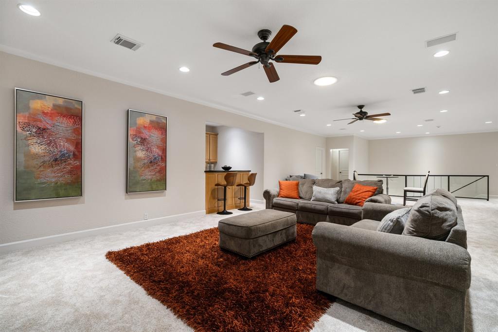There are several bonus rooms to enjoy inside this home, including this game room with custom wet bar. 