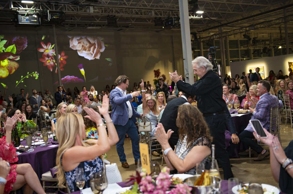 Andrew and Cheryl Schoellkopf celebrate their live auction win (Photo by Tamytha Cameron)
