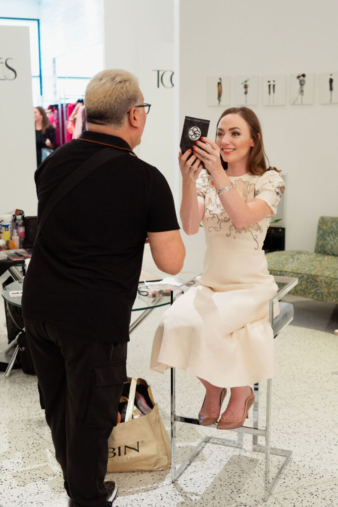 Julia Robinson admires the work of make-up artist Edward Sanchez  at the Orange Show's Dalidada dress-up party at Tootsies.(Photo by Jane Perkins)