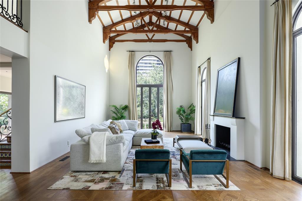The living room at 3828 Turtle Creek Drive has plenty of natural light and 25-foot soaring ceilings topped by wood truss-work.