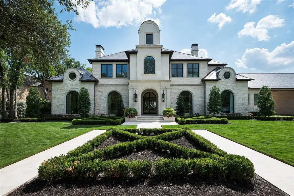 Enter 5414 Elden Drive through formal boxwood gardens.