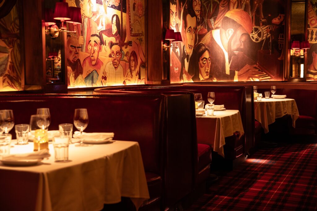 Reserve one of the white-clothed tables and gape at the framed vintage black-and-white photos of those movie-making icons or play “Who can guess that celebrity likenesses” depicted on those painted murals in the dining room. (Photo by Becca Wright)