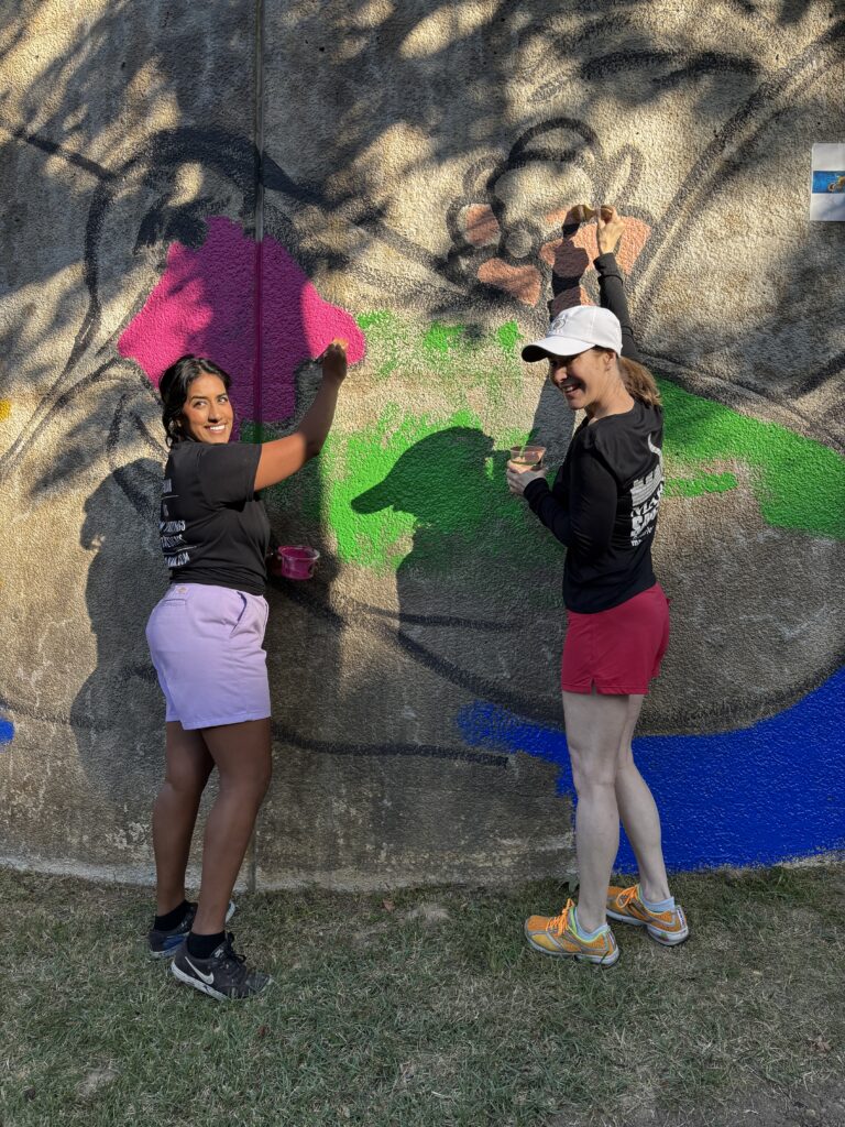 Artists Amy Malkan (left) and Marlo Saucedo were on hand for the Community Paint Day for the mural they created for The Woodlands' 50th anniversary.  The mural is on The Waterway near the Cynthia Woods Mitchell Pavilion. (Photo by Laura Landsbaum)