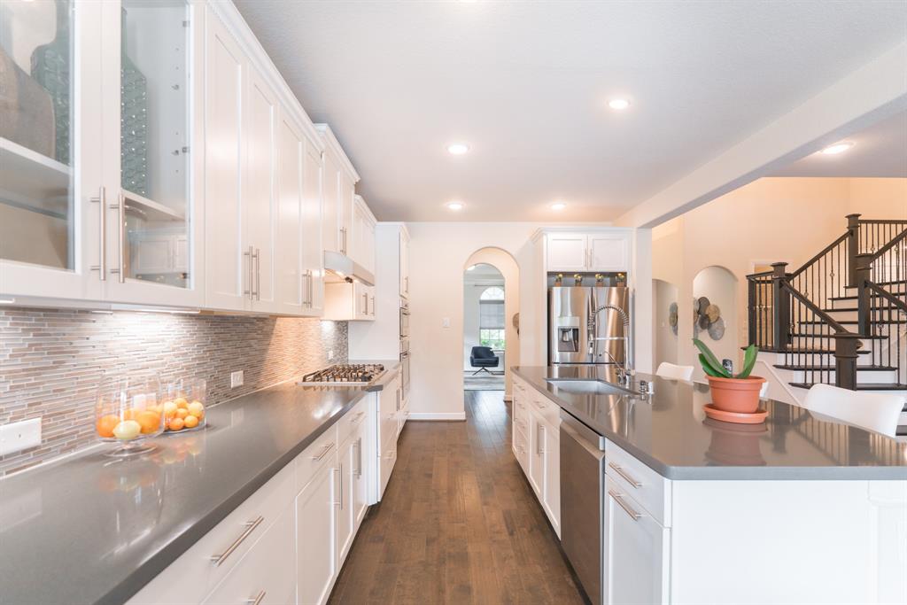 The kitchen is the heart of the home with a large breakfast bar and island, perfect for morning coffee and conversation. 