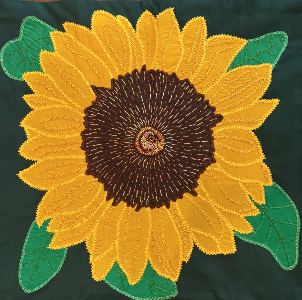 Honduran artist Rosa's warm hued reinterpretation of Lydia Bodnar-Balahutrak's sunflower painting brightens a room, as part of the “Side by Side, 20 x 20: Honduras Threads” exhibition.