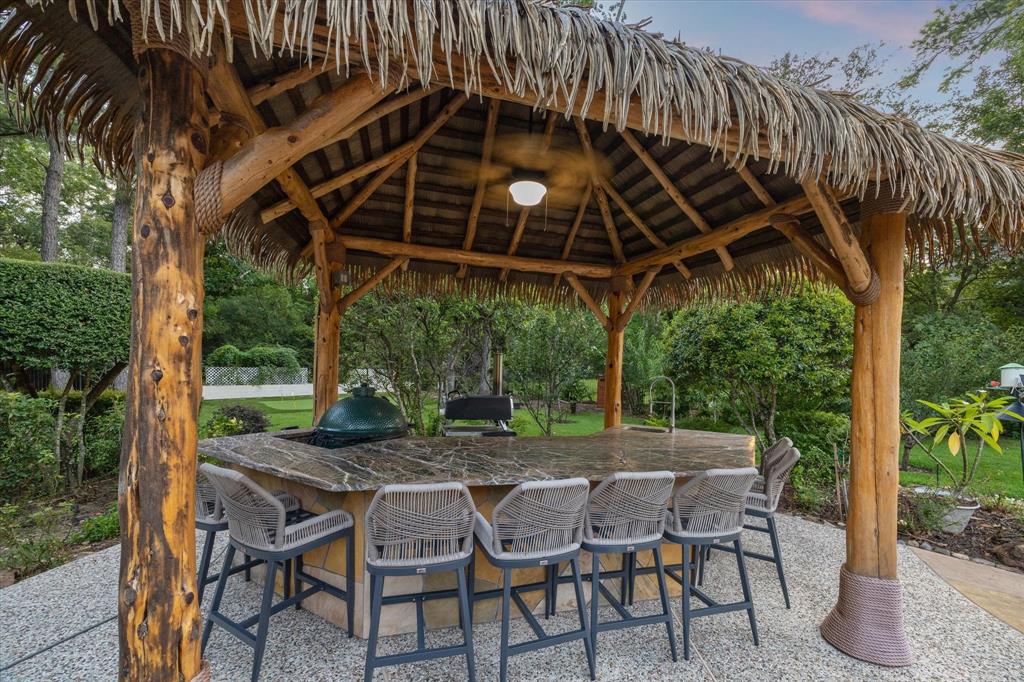 It even features your very own tiki bar, as well as a putting green, summer kitchen, and lovely swimming pool. 