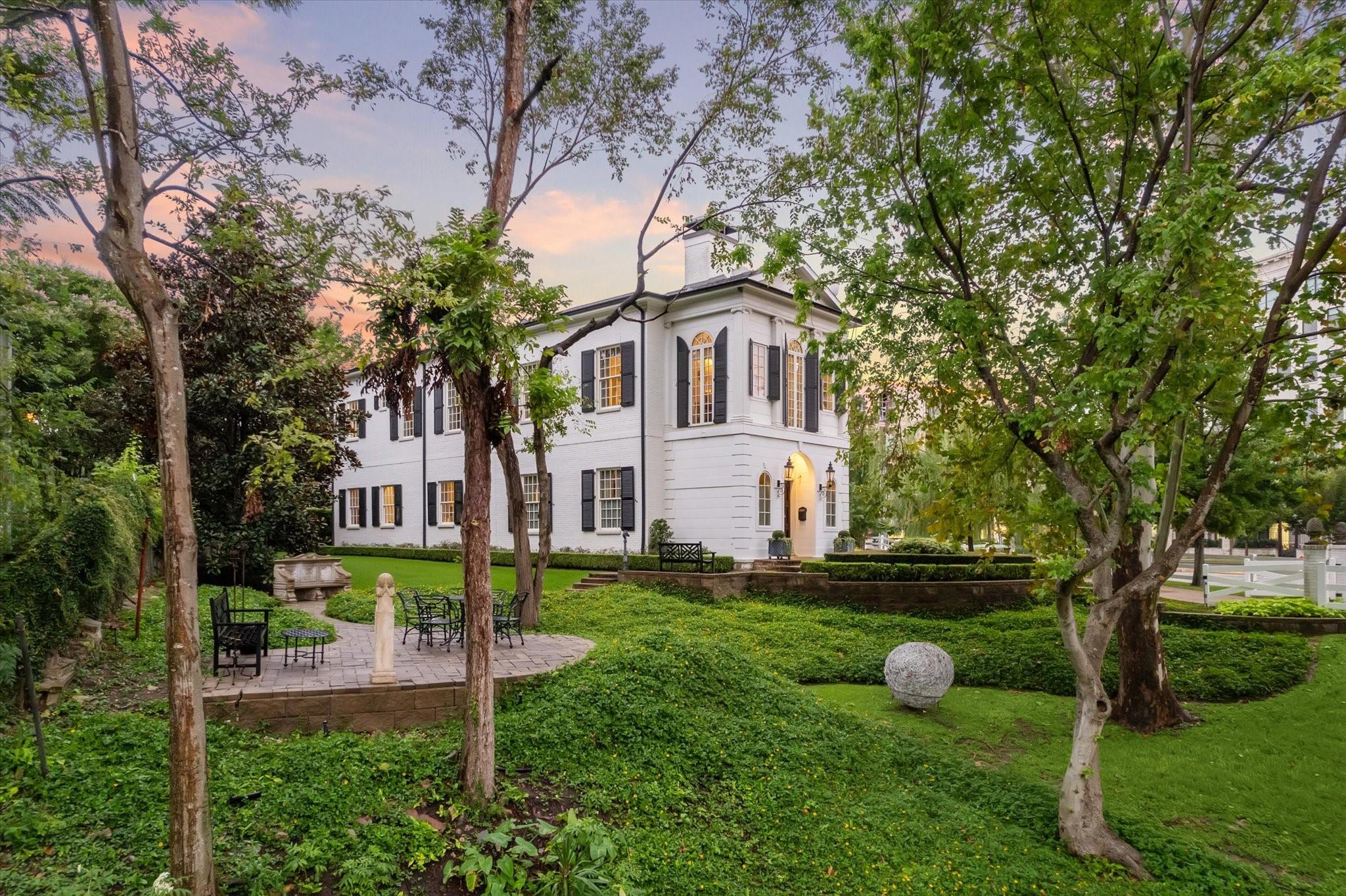 Luscious gardens complete with a spacious patio surround the house at 6024 Memorial Drive in Glen Cove.