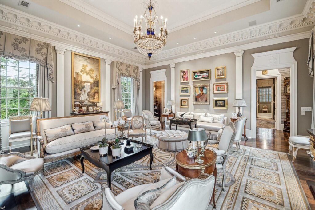 The formal living room embraces visitors with natural light and dazzles with opulent wall ornamentation.