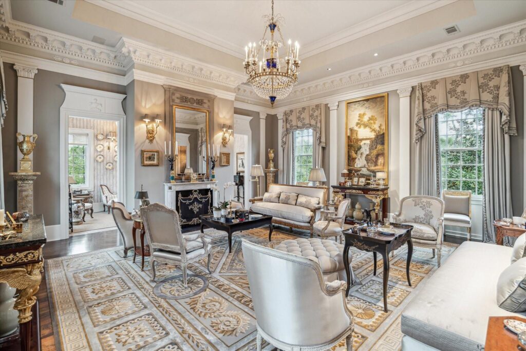 The grand living room on the second floor receives ample lighting and features ornate paneling in the house at 6024 Memorial Drive in Glen Cove.