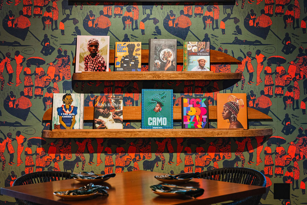Inside, visitors can explore a curated book wall featuring selections from the Black-owned bookstore Kindred Spirits. (Photo by StuffBenEats)
