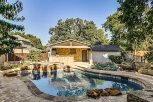October 2024 – 3728 Somerset Lane – The lagoon style pool and spa with an outdoor covered kitchen