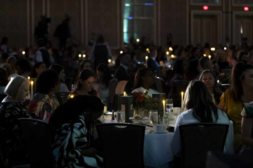 Texas Trailblazer Awards Luncheon attendees with candles to represent their commitment to shining a light on survivors of domestic violence (Photo by Tamytha Cameron and Celeste Cass)