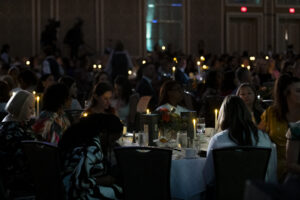 Texas Trailblazer Awards Luncheon attendees with candles to represent their commitment to shining a light on survivors of domestic violence (Photo by Tamytha Cameron and Celeste Cass)
