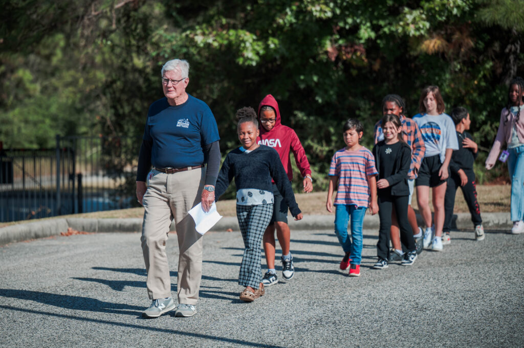 A Pavilion Partner leads Spring ISD students into the Cynthia Woods Mitchell Pavilion for Fine Arts Education Day in October, 2024. (Courtesy of the CWMP)