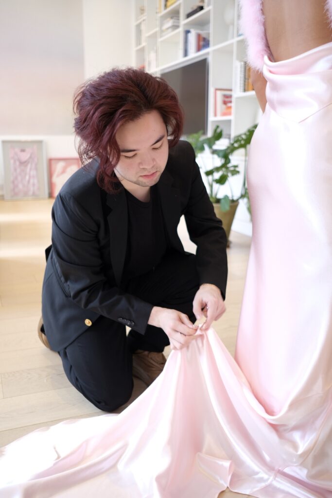 Designer Michael May of Christian Cowan puts finishing touches on Conally Bell's train. (Photo by Beth Hutson)