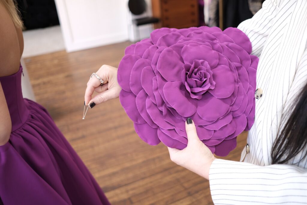 Emily Kate Bell gets a helping hand from her stylist Bonnie Thompson Smith. (Photo by Beth Hutson)