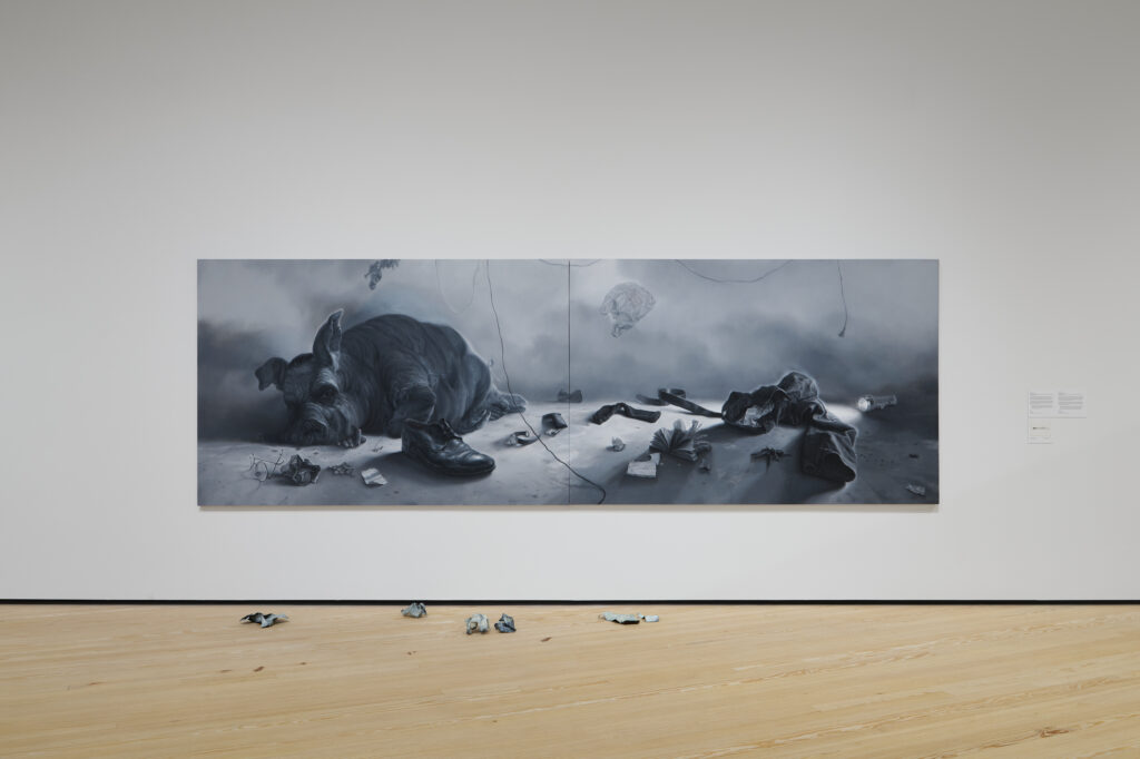 Vincent Valdez, Eaten (In America) (2018-19). Oil on canvas. A sixteen-foot diptych that critiques modern excess, featuring a pig (modeled after J. Edgar Hoover) in a barren, post-apocalyptic landscape. (Photo courtesy the artist)