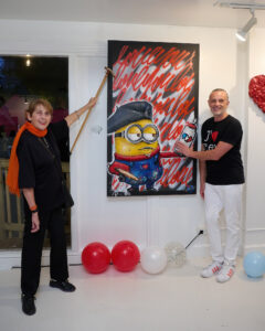 Anne Breux, Mr. D 1987 celebrate the opening of “Frenchies & Friends” at Alliance Francaise de Houston. (Photo by Charlie Horse Photography)