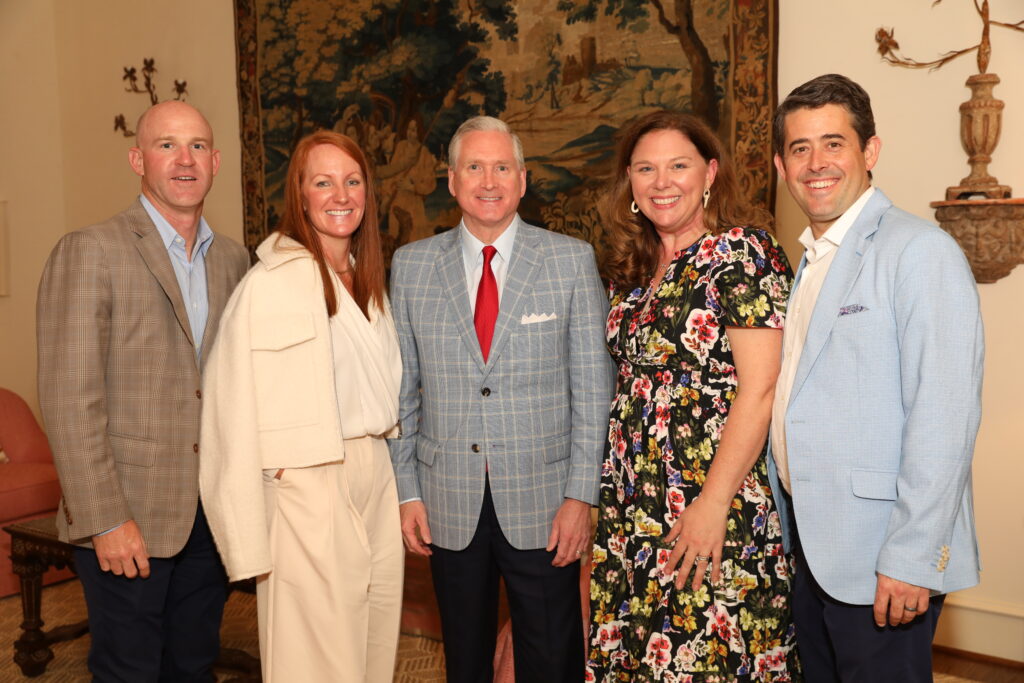Shane and Cory Bowen, 2024 TRAINS Honorary Chair, G. Brint Ryan; and Becky and Pastor Arthur Jones enjoying the TRAINS Sponsor Party at the home of Beth and Fin Ewing (Photo by Tamytha Cameron Photography)