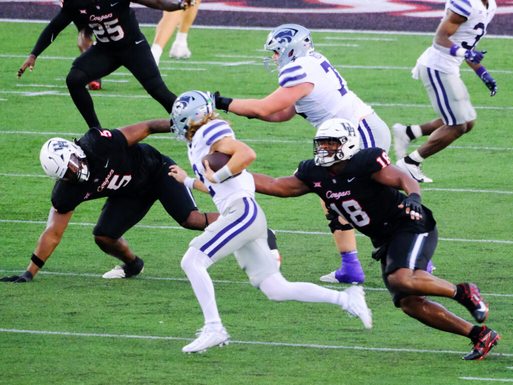 University of Houston's defense is relentless in its pursuit. Anthony Homes Jr. (No. 18) and Keith Cooper Jr. (No. 5) just keep coming.  (Photo by F. Carter Smith)