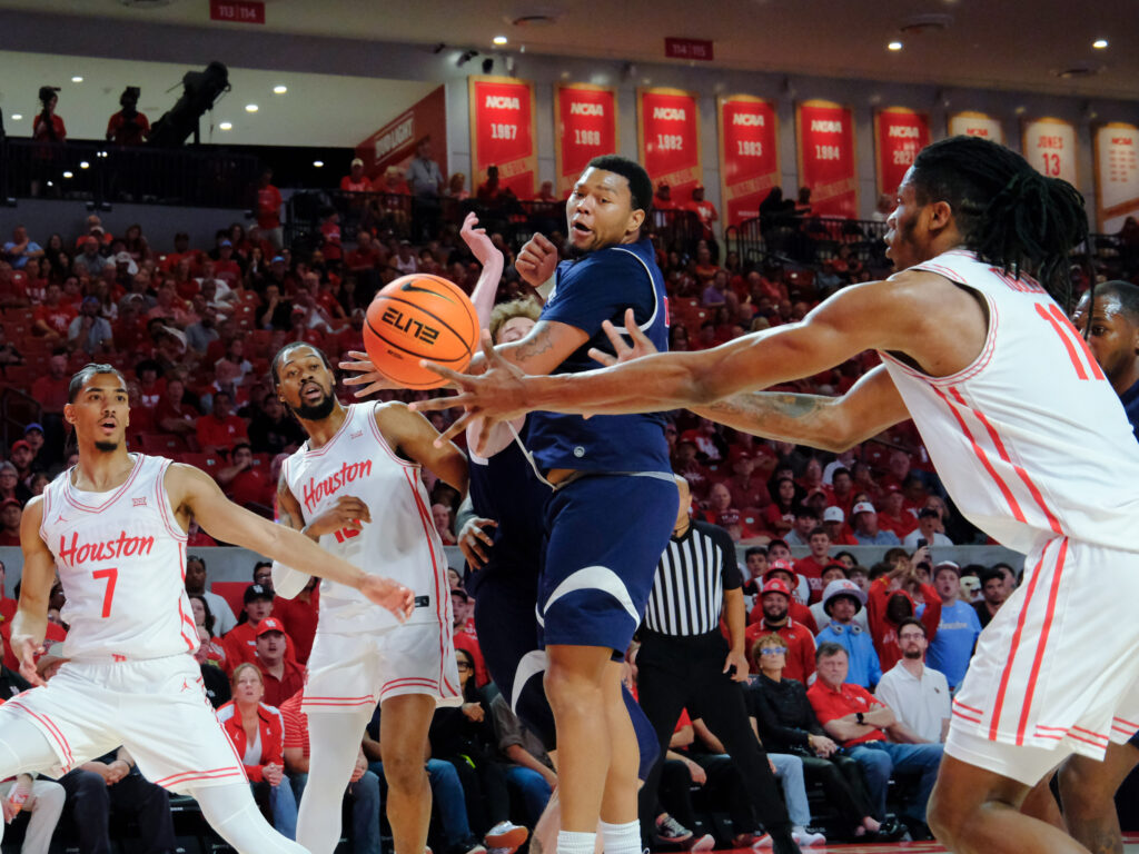 JoJo Tugler gets an open shot from a sweet pass, courtesy of UH point guard Milos Uzan. (Photo by F. Carter Smith)