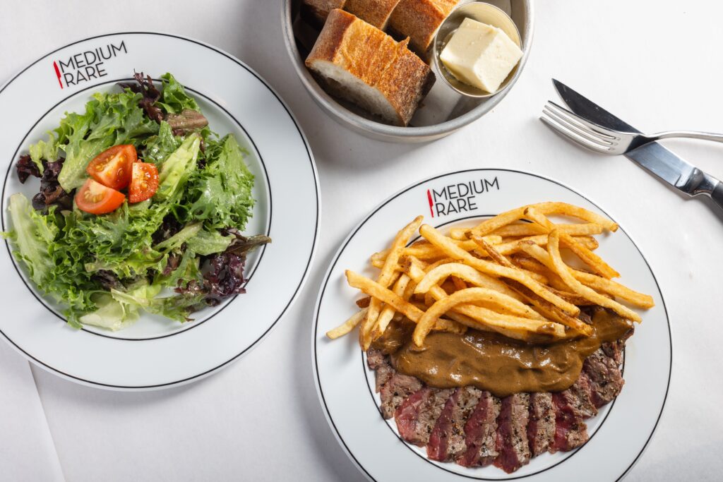 In addition to steak frites, the prix fixe menu includes a mixed green salad and artisan-style bread.  (Photo by Alex Staniloff)