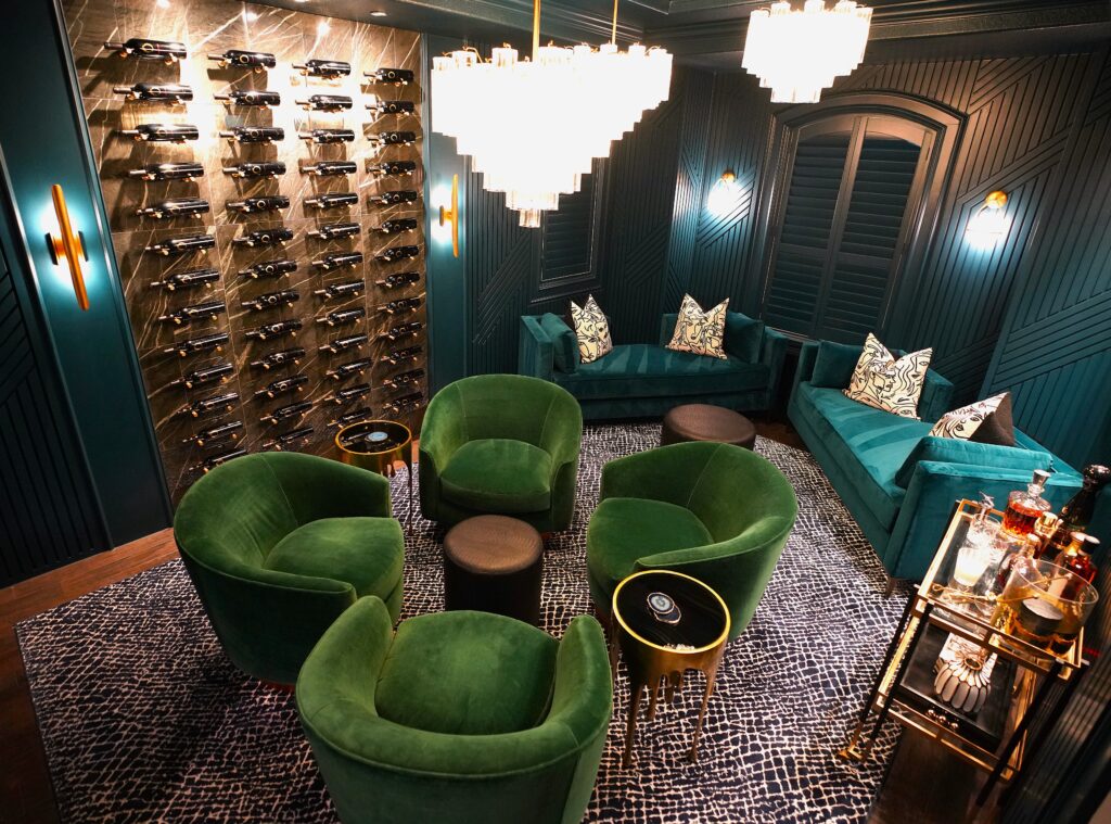 Four green club anchor one end of the new wine room in the former dining room, reimagined by Laura Starzyk Interiors.