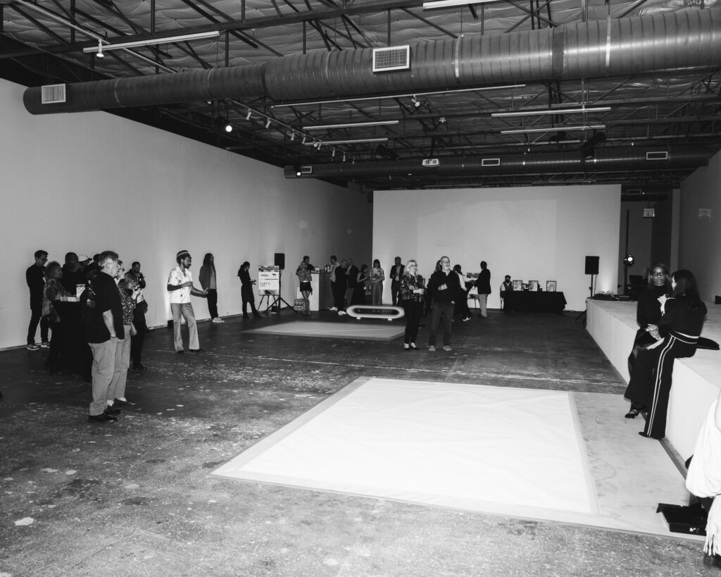 The three-part performance had guests shuffling from one piece of paper to another in the large gallery so they wouldn't miss any part of it. (Photo by Malcolm Herod)