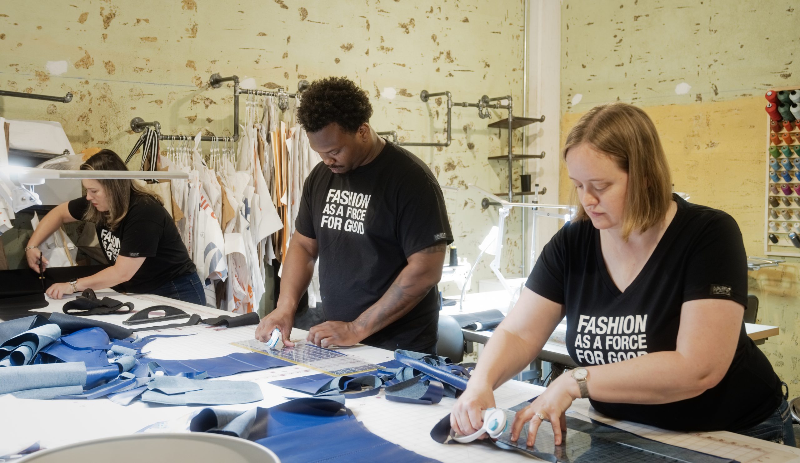 Magpies & Peacocks seamsters and seamstresses working to create the nonprofit's couture clothing. (Photo by Jack Thompson)