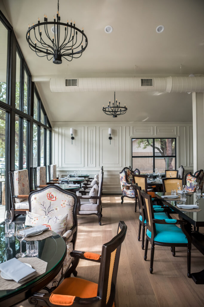 Inside the pretty light-filled dining room, appointed with cushy bergère chairs. (Photo by Tracy Ling)