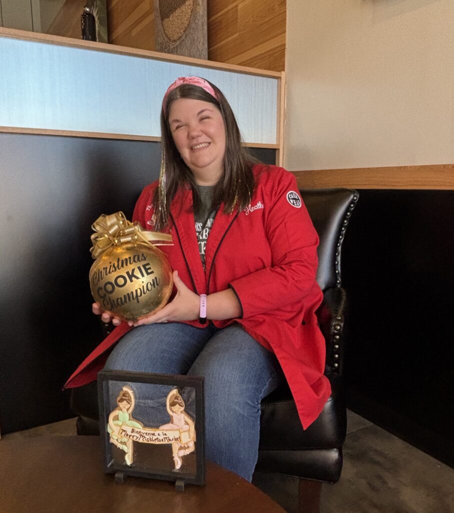 Winner Heather Brookshire with her ornament from Food Network's "Gingerbread challenge," along with the ballerinas from the display. (Photo by Laura Landsbaum)