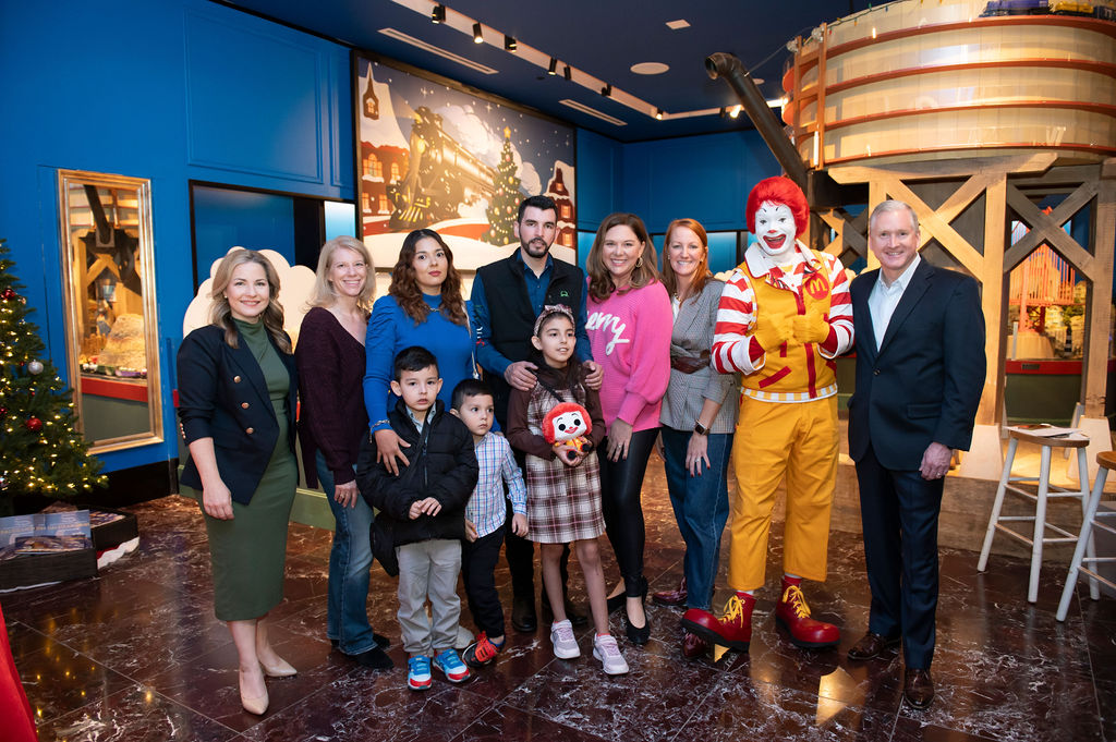 Back Row: L-R: Michelle George, Bank of Texas, Jill Cumnock, CEO of Ronald McDonald House, Fabiola Andrade (Maria’s mom), Jose Andrade (Maria’s dad), Becky Jones, Co-chair, Cory Bowen, co-chair, Ronald McDonald, Brint Ryan, honorary chair. Front row- L- R: Luis Andrade (brother), Jose Andrade (brother) and Maria Andrade (kid conductor) (Photo by Tamytha Cameron Photography)