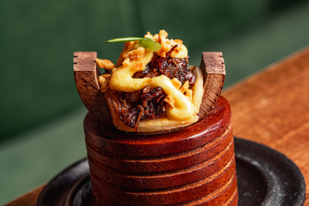 The Cheeky Pun (beef cheek taco) at Rye is served on a unique wooden creation made by Grace Tudor. (Photo by Samantha Marie)