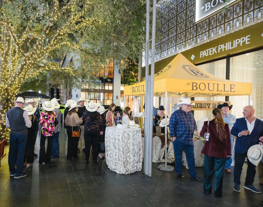 The de Boulle holiday party in River Oaks District spills over onto the terrace where guests get their western hats personalized.  (Photo by Johnny Than)