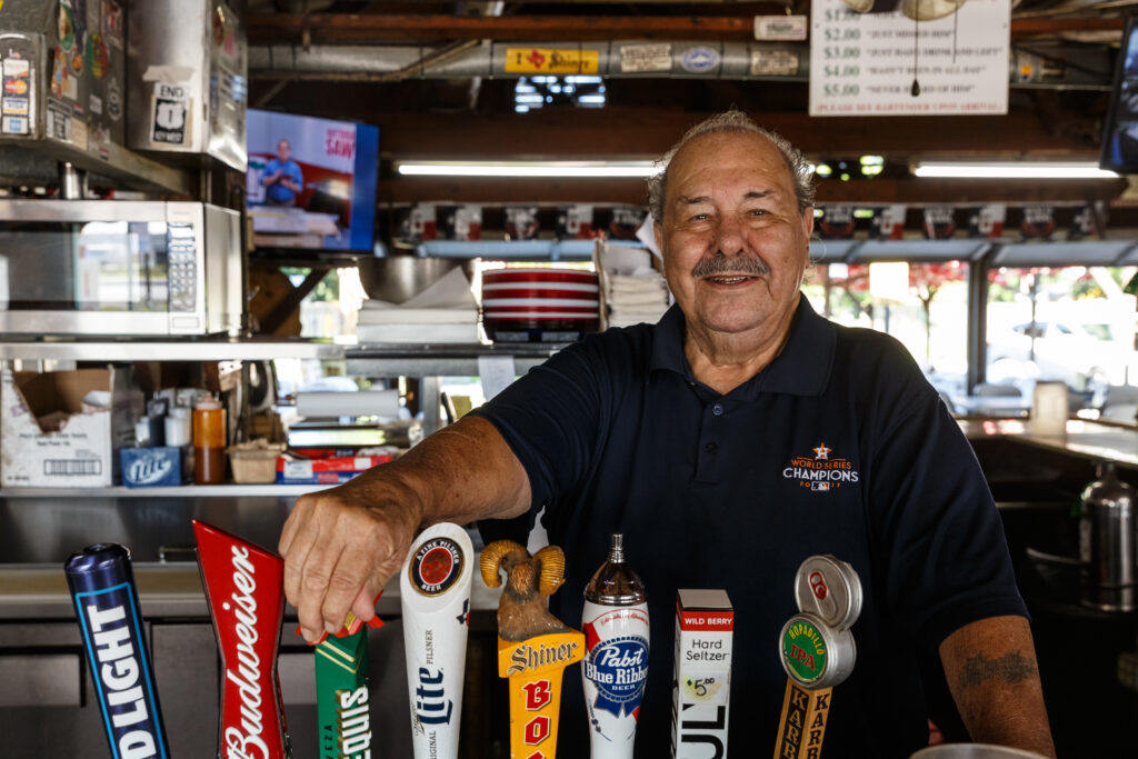 In 1978, Villagomez opened a beer garden to the right of his small barber shop, which has since become a beloved spot for many.