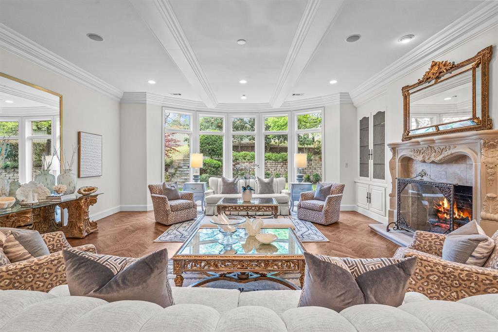 At 1802 Deepdale Drive, you’ll find a living area with a fireplace and floor-to-ceiling windows, plus a wet bar and a kitchen with a butler’s pantry.