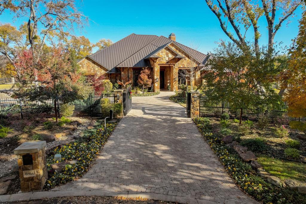 This rustic charmer on hole 4 in Mira Vista has four bedrooms and 4.5 bathrooms in the main house.