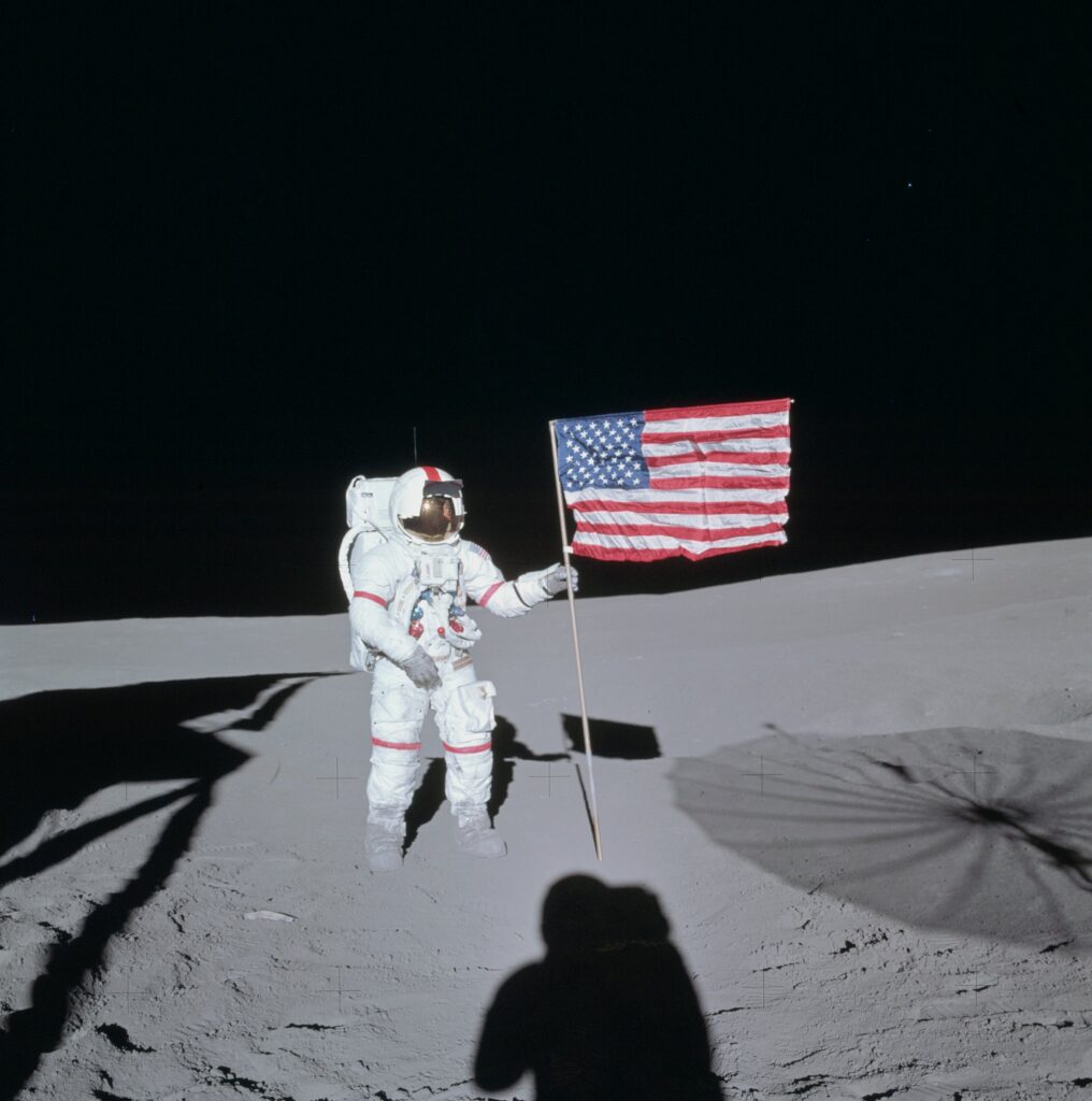 Apollo 14 commander Alan Shepard plants an American flag with pride. 