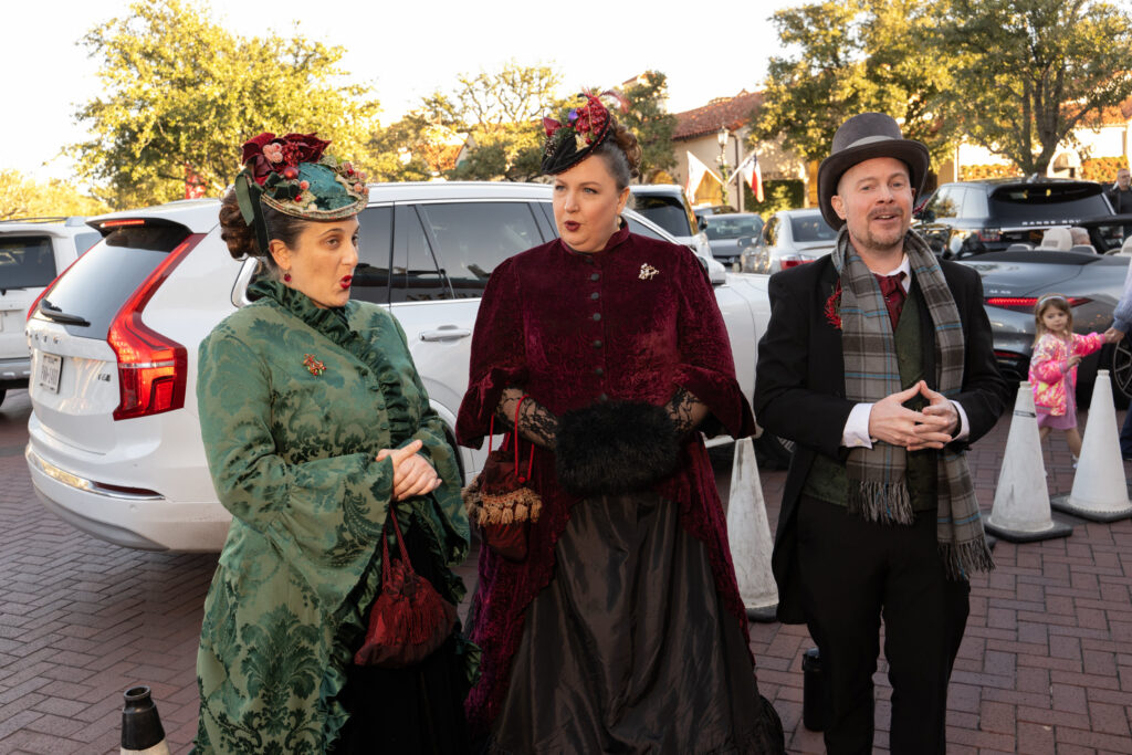 Carolers sing to guests at the Highland Park Village Christmas event. (Photo by George Fiala)
