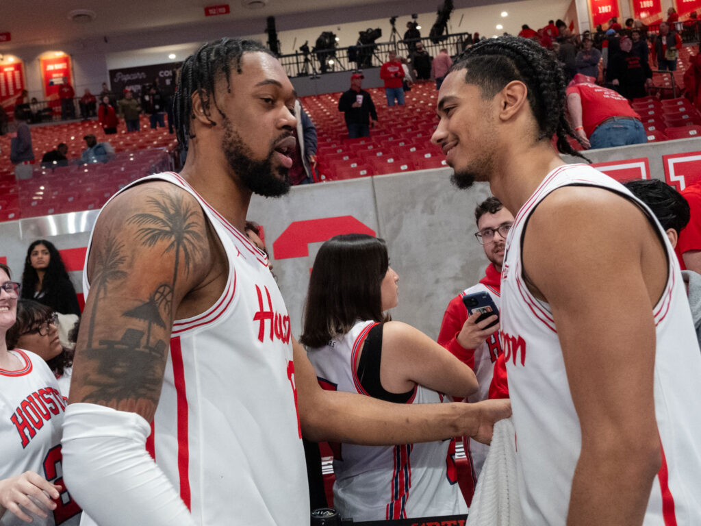 University of Houston veteran forward J'Wan Roberts gives new starting point guard Milos Uzan some love. (Photo by F. Carter Smith)
