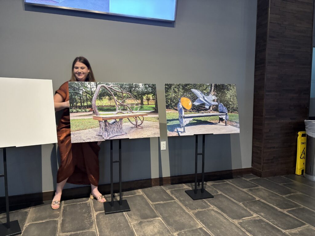 The Woodlands Arts Council's Kayla Trascher unveils "Windswept Oak" and "Flight to the Sun" benches at the Woodforest Bank Club on December 3.