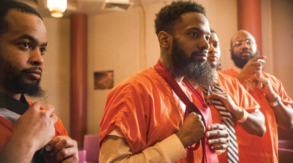Incarcerated fathers try on ties for Daddy Daughter dance in documentary “Daughters” (Courtesy of Netflix) 