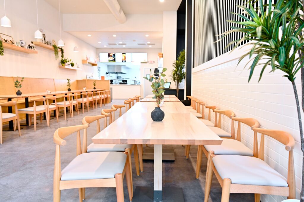 Inside the new Pok Pok Po. The reimagined modern quick-service restaurant is situated within a 2,000-square-foot space with a 55-seat dining area that blends light wood tones, accented by subtle pops of color and greenery. (Photo by Alex Montoya)