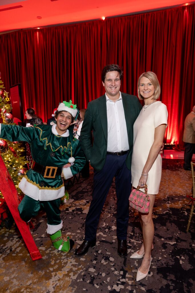 Lindsey & John Hohlt with holiday elf at the Ambassadors for Texas Children's Hospital holiday party. (Photo by Jenny Antill)