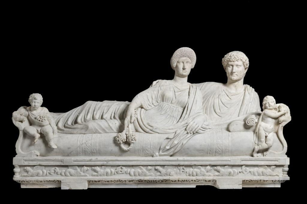 "Lid with Reclining Couple" is a poignant representation of eternal companionship in Roman funerary art. (Courtesy of Torlonia Foundation)